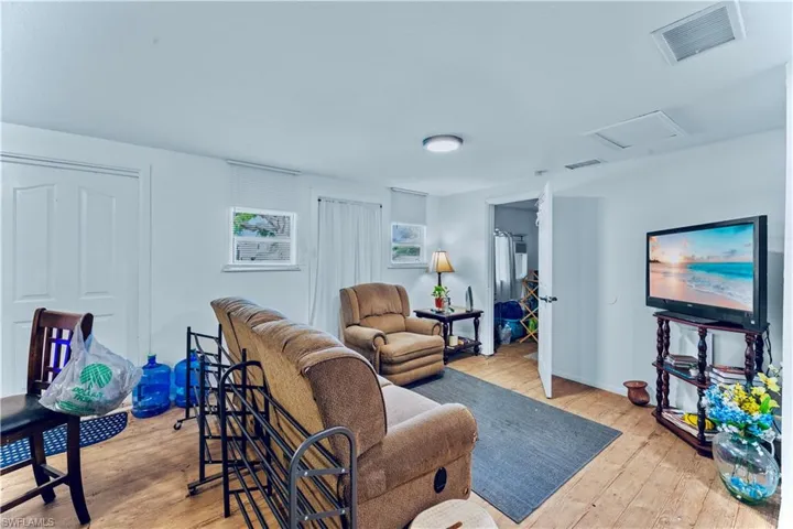 Living room with light hardwood / wood-style floors