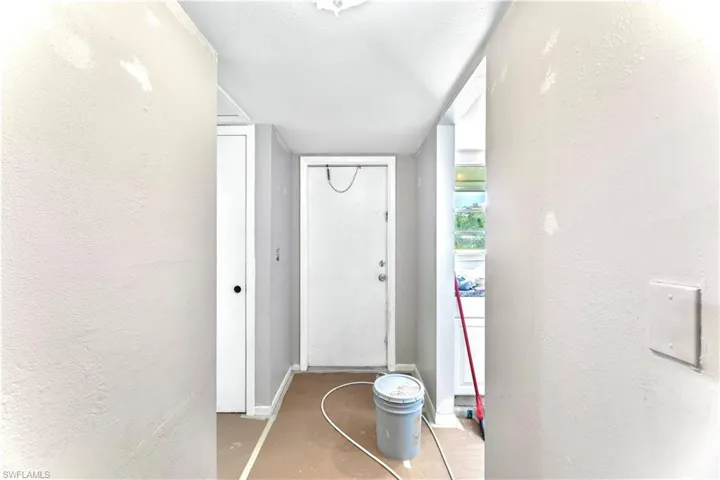 Hallway featuring a textured ceiling