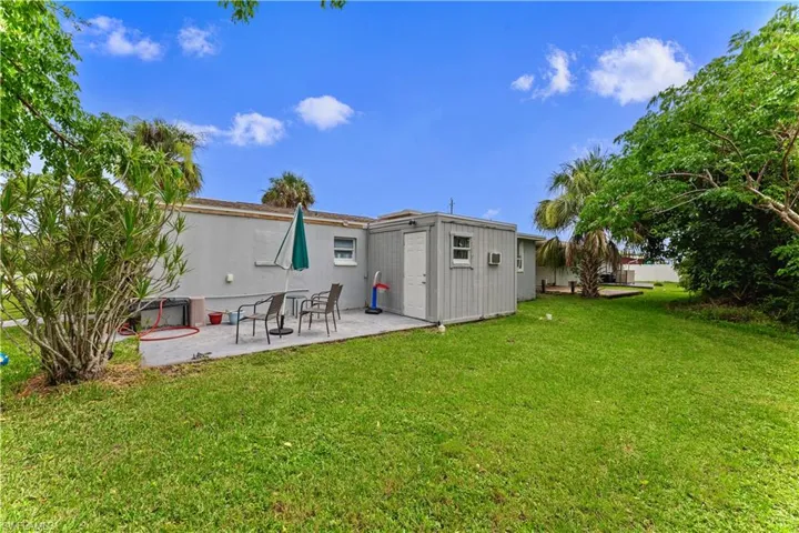 Back of property with a patio and a yard