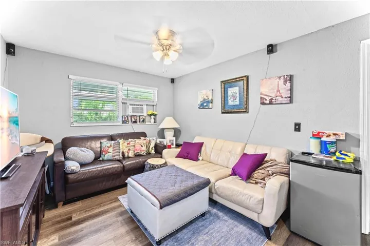 Living room featuring wood-type flooring and ceiling fan