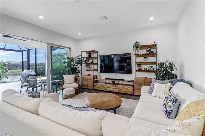 Living area featuring recessed lighting, a sunroom, and wood finished floors