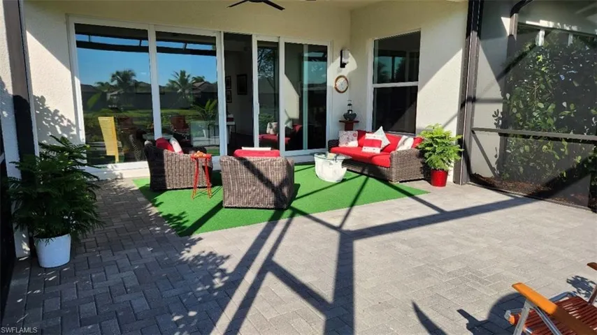 View of patio / terrace featuring an outdoor living space, a ceiling fan, and a sunroom