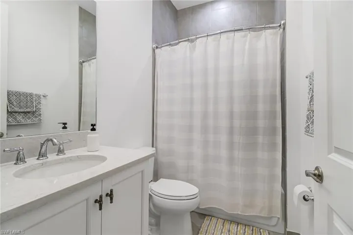 Bathroom with vanity and shower / bath combo with shower curtain