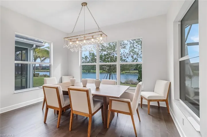 Dining area with wood finished floors and a water view