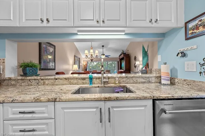 White kitchen, stainless sink, ceiling fan, dishwasher