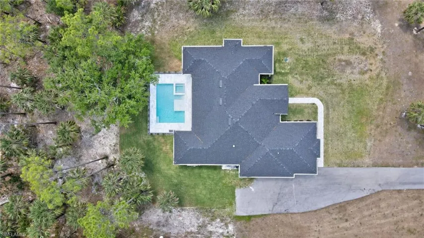 View of subject property featuring a pool