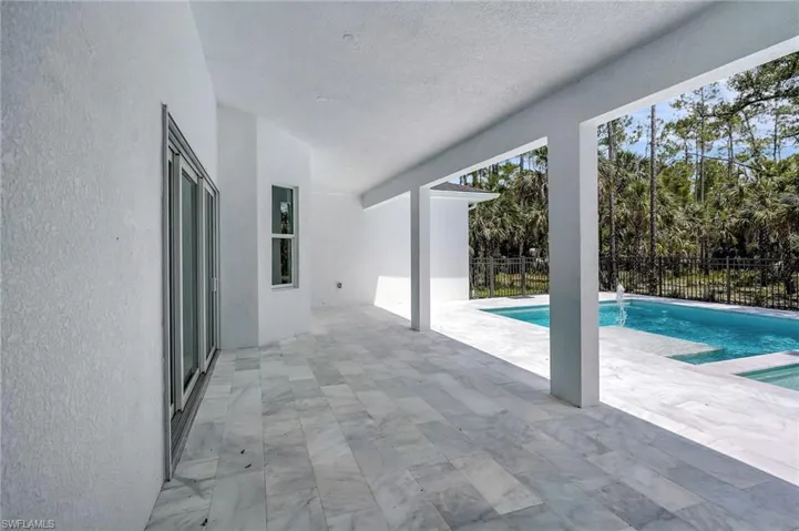 View of pool featuring a patio and fence