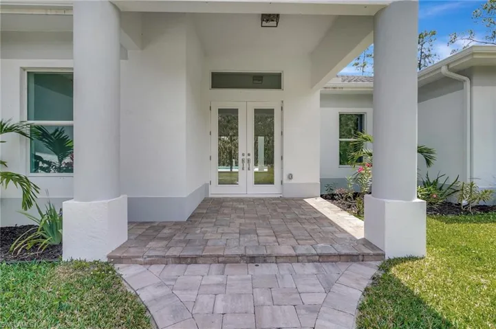 Entrance to property with french doors and stucco siding