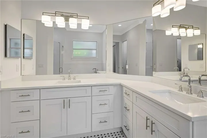 Full bath with a shower stall, vanity, and tile patterned floors