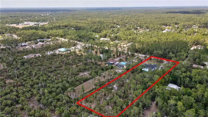 Aerial view of property's location with a heavily wooded area and property boundaries highlighted