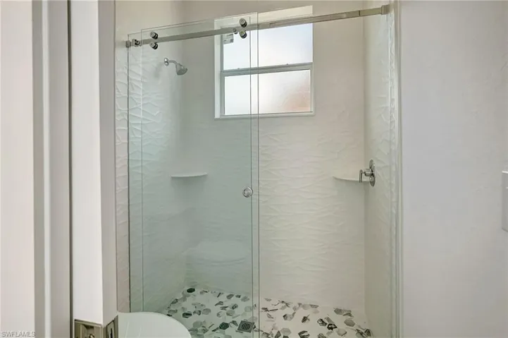 Full bath with a shower stall and toilet