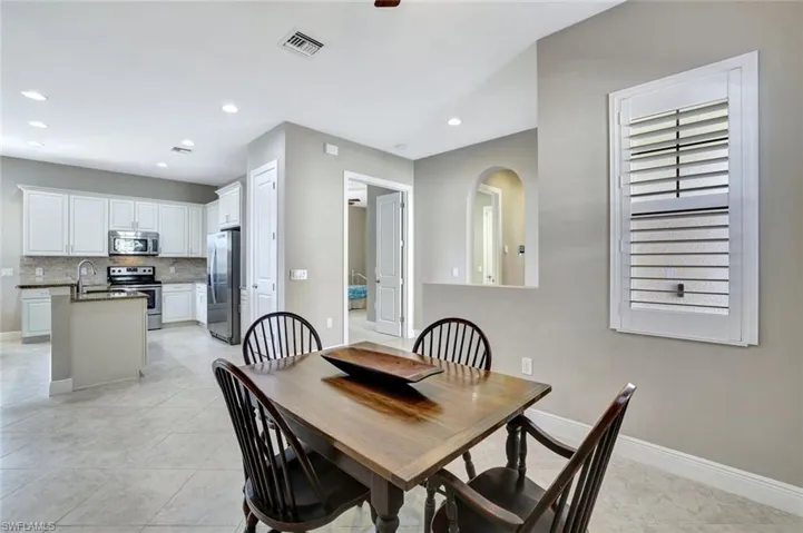 Dining space featuring light tile patterned floors and recessed lighting