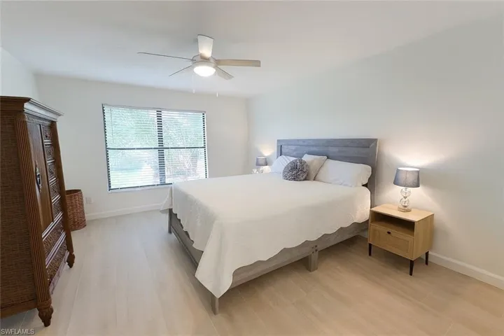 Bedroom with light wood-type flooring and a ceiling fan