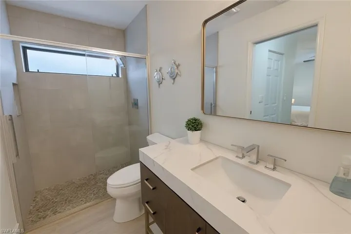 Ensuite bathroom with vanity and a stall shower
