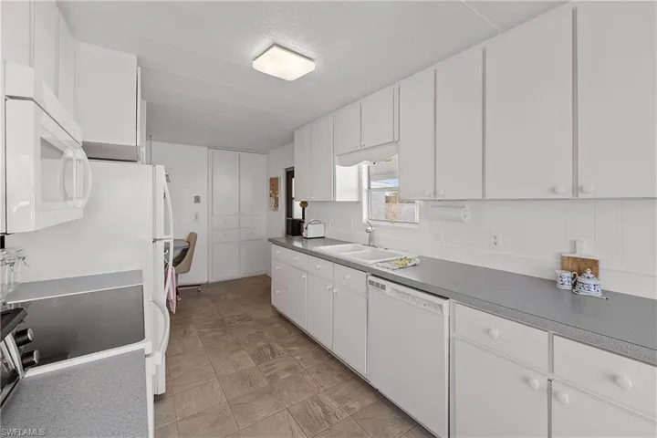 Kitchen with white appliances and white cabinets