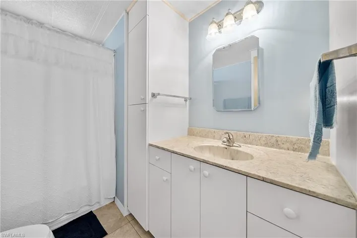 Bathroom with vanity and light tile patterned floors