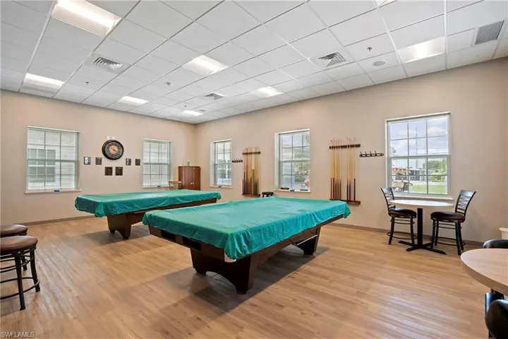 Rec room with a drop ceiling, pool table, and plenty of natural light