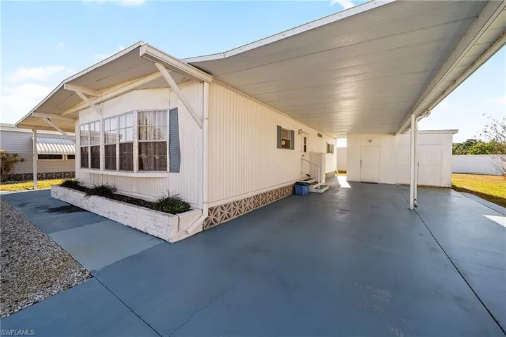 View of home's exterior with an attached carport and entry steps