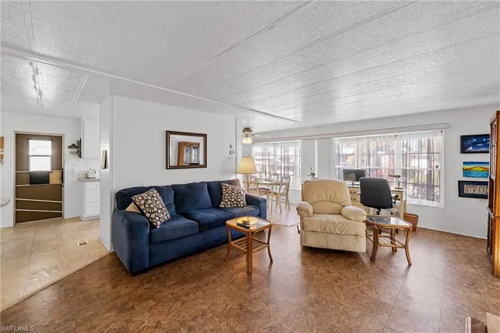 Living area with a textured ceiling and a ceiling fan