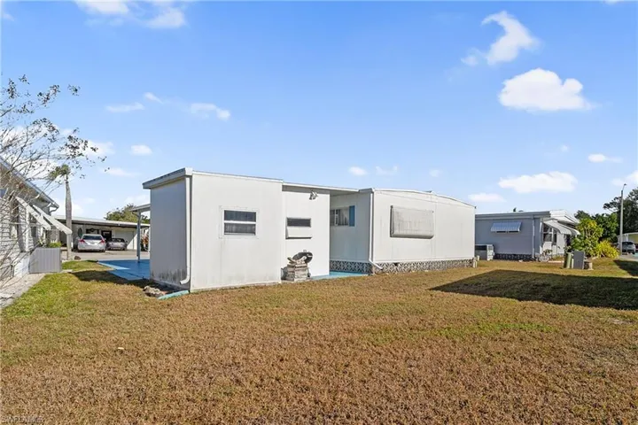 Back of house with a yard
