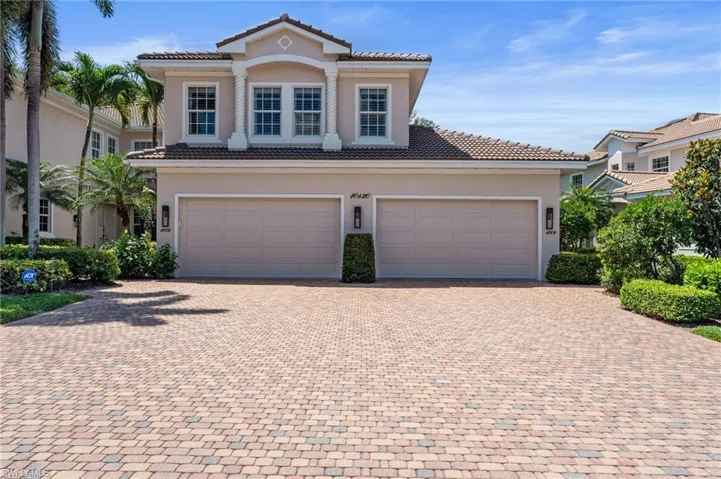 Mediterranean / spanish house featuring a tiled roof, stucco siding, and decorative driveway