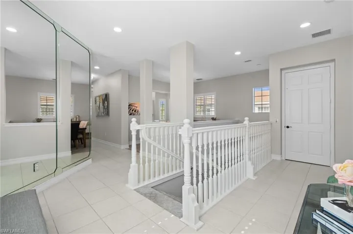 Hallway featuring baseboards, recessed lighting, an upstairs landing, tile patterned flooring, and visible vents
