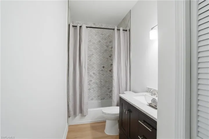 Stylish guest bath featuring newly updated tile and flooring