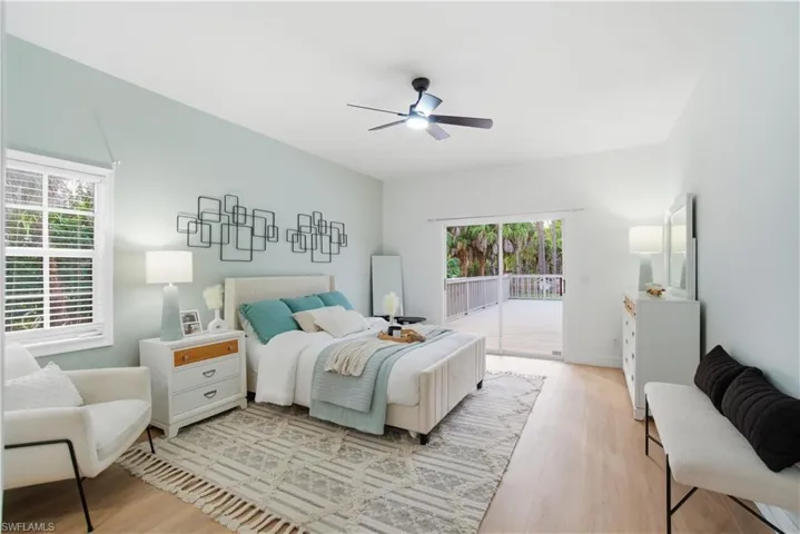 A serene primary retreat with private deck access, peaceful nature views, generous space, and beautiful natural light for the ultimate place to unwind