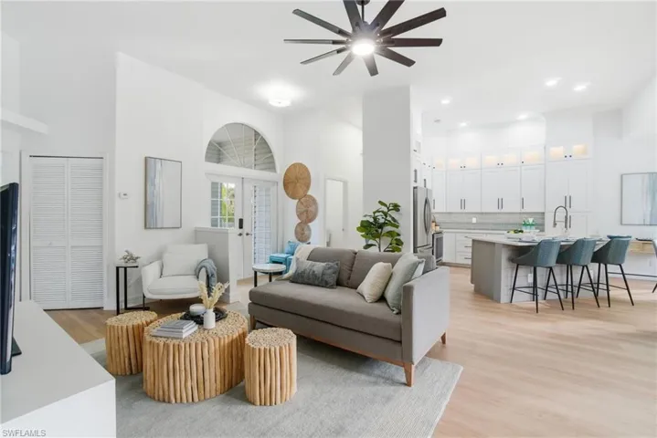 Bright, airy living with volume ceilings and a beautiful breakfast bar that invites friends, family, and easy conversation