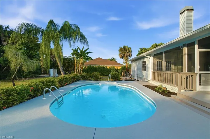Enjoy the best of Florida living with a large poolside sundeck and screened covered lanai for relaxing, dining, and entertaining year-round