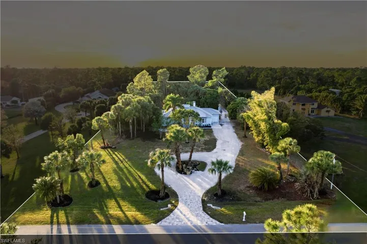 Twilight aerial showcasing the property's scale and privacy
