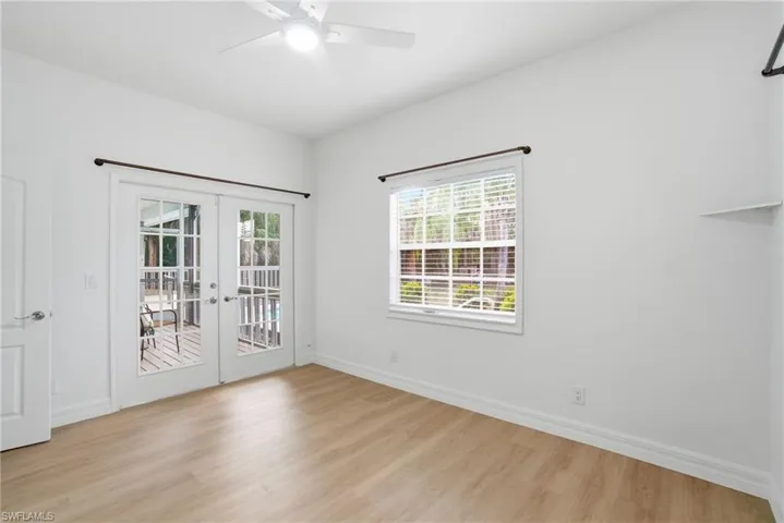 Guests will love this light-filled bedroom with its own French door entry to the deck and pool.