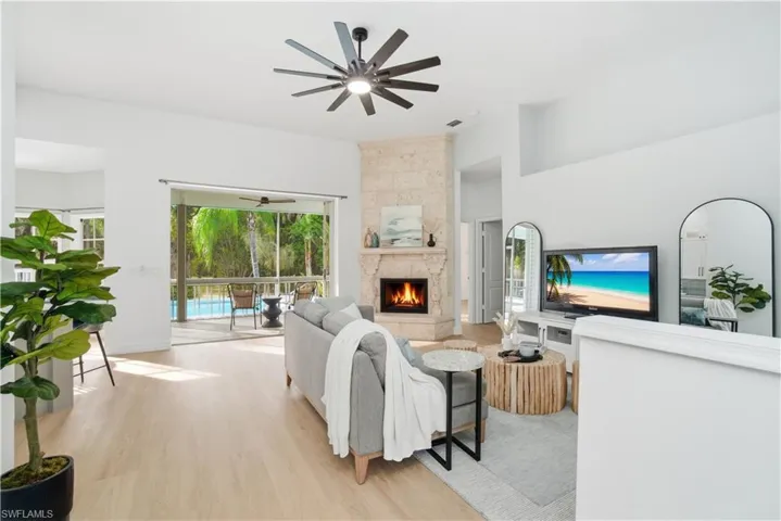 Light-filled living anchored by a stunning custom travertine fireplace, with effortless indoor-outdoor flow that invites you to relax, gather, and enjoy true Florida living