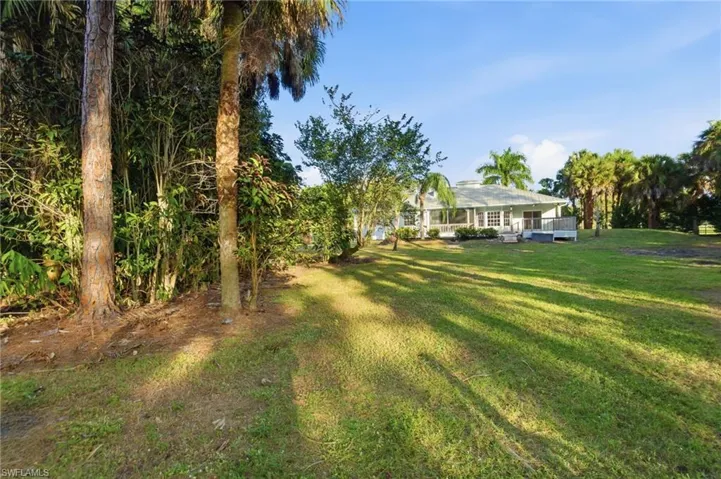 The rear of the home showcases expansive outdoor living and poolside design