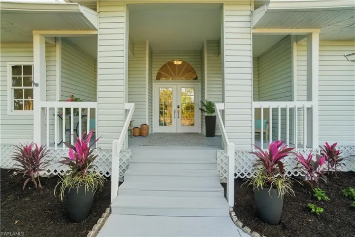 Southern charm meets relaxed coastal living the moment you step onto this gracious front porch