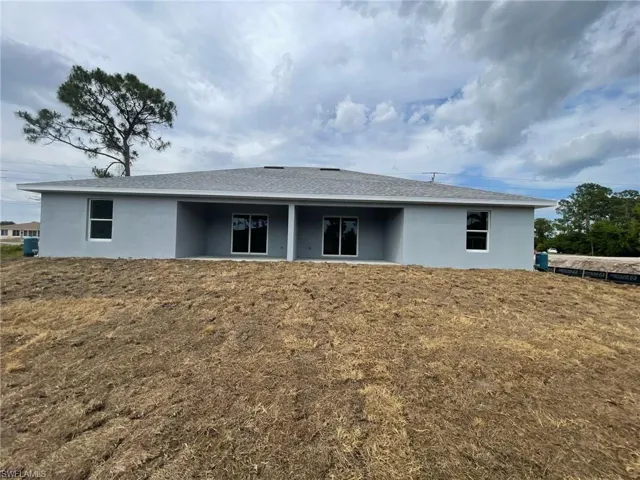 Rear view of property with stucco siding