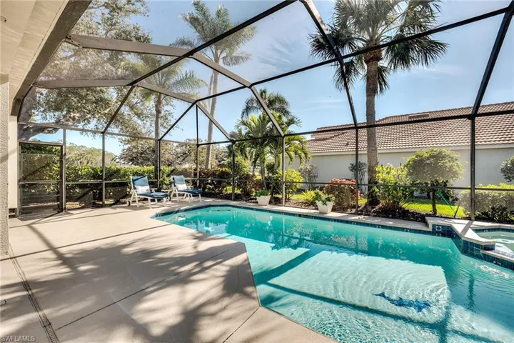 View of pool with a lanai, a patio area, and an in ground hot tub