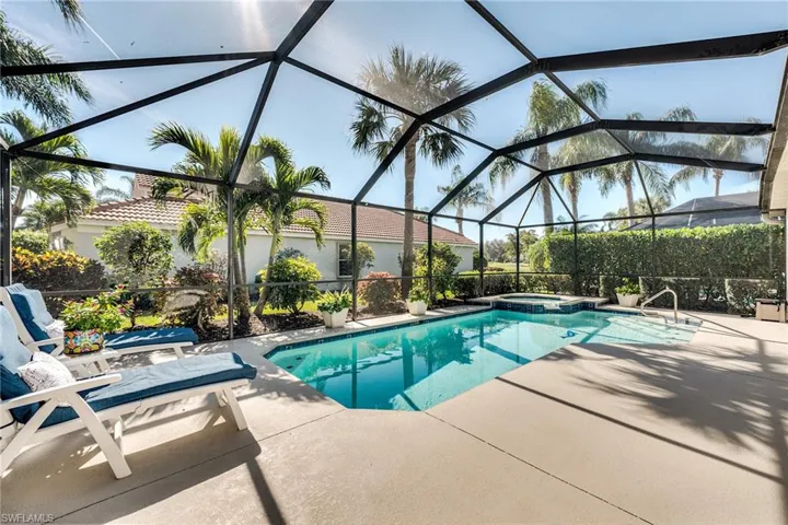 View of swimming pool featuring an in ground hot tub, a lanai, and a patio area