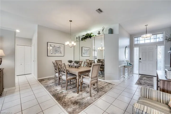 Tiled dining space featuring a notable chandelier