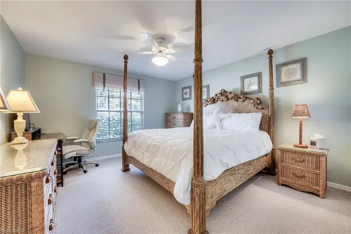 Carpeted bedroom with ceiling fan