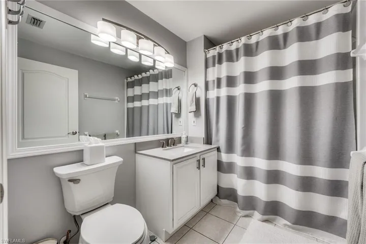 Bathroom with tile patterned flooring, vanity, and toilet