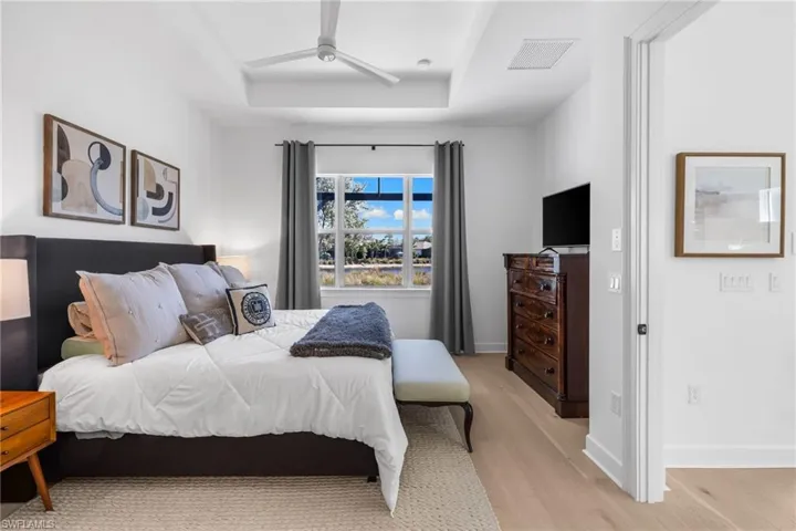 Serene pool and lake views from your primary bedroom retreat.