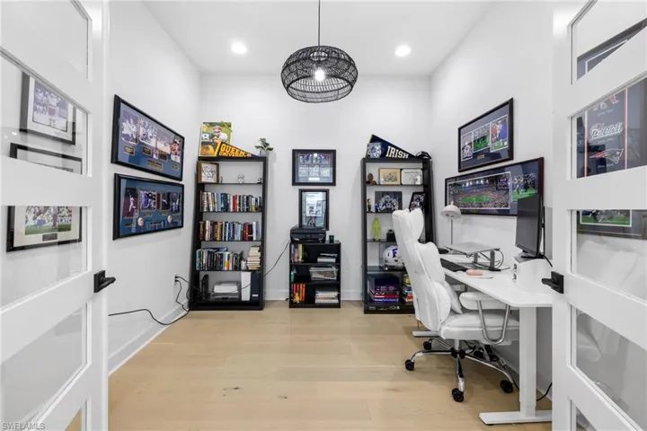 French doors invite you into the office with premium wood floors