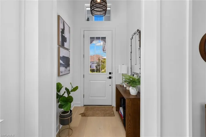 Entryway with wood finished floors and baseboards