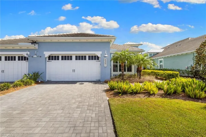 Mediterranean / spanish-style house with stucco siding, decorative driveway, a tiled roof, a garage, and a front yard