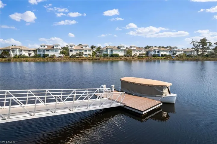 Dock with a water view and a residential view