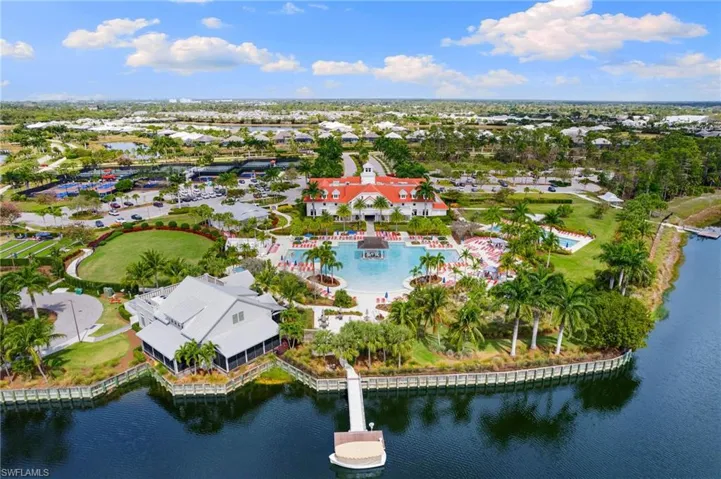 Bird's eye view of a nearby body of water and a pool