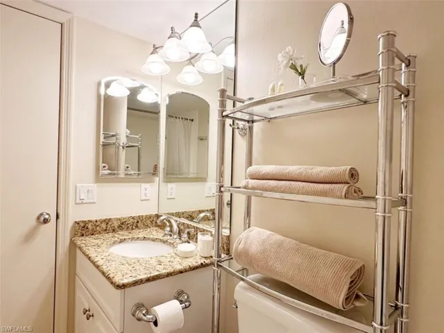 Full bathroom featuring vanity and curtained shower