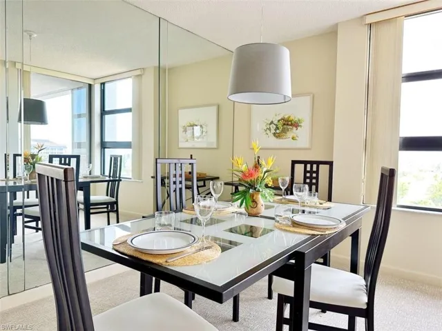 Dining area featuring light carpet and baseboards