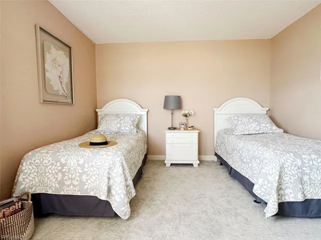 Bedroom with carpet and a textured ceiling
